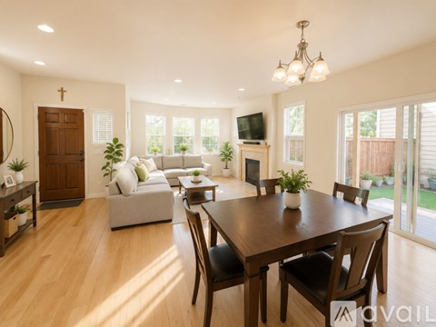 A modern living room with a wooden dining table and chairs.