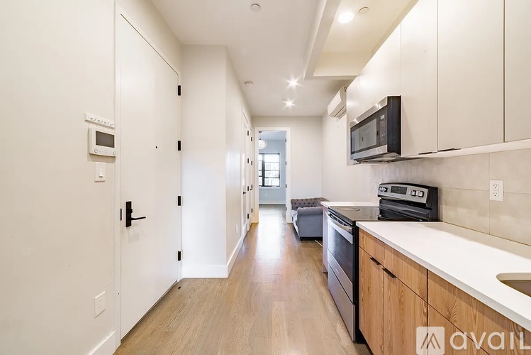 A kitchen with white cabinets and a white counter top.
