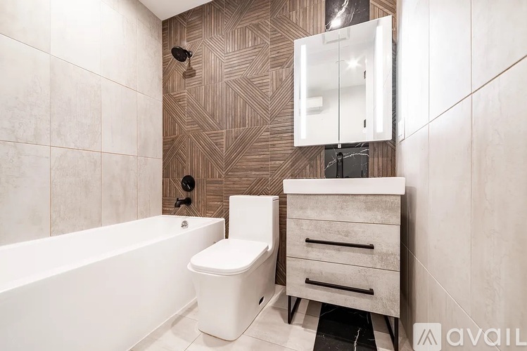 A bathroom with a white tub, toilet, and sink.