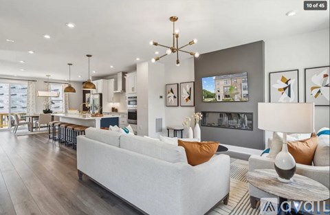 A modern living room with a white sofa and a fireplace.