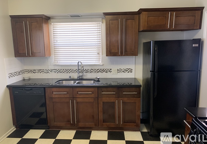 A kitchen with black and white checkered floor.