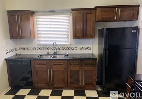 A kitchen with black and white checkered floor.