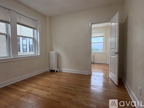 A room with wooden floors and a white door.