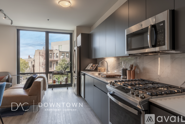 A modern kitchen with a stove top oven and a microwave above it.