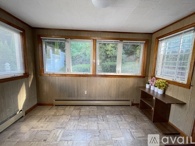 A room with wooden walls and a tiled floor.