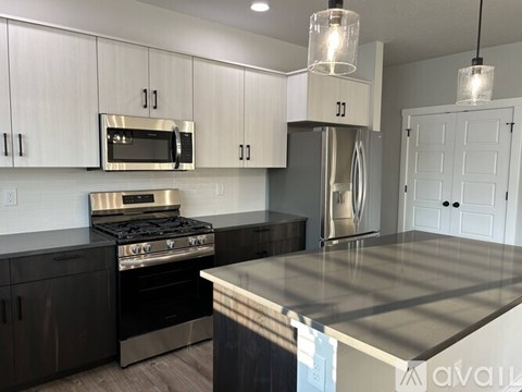 A kitchen with a stove top oven and a microwave above it.