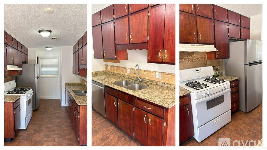 A kitchen with brown cabinets and a white stove top oven.