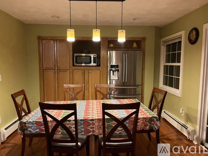 A dining room with a table set for four.