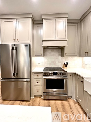 A kitchen with a stainless steel refrigerator and oven.