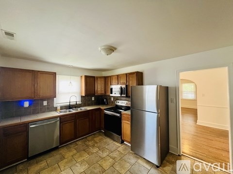A kitchen with wooden cabinets and stainless steel appliances.