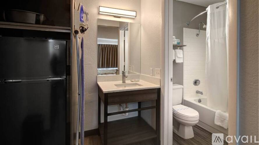 A bathroom with a sink, toilet, and shower.