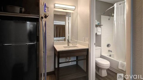 A bathroom with a sink, toilet, and shower.