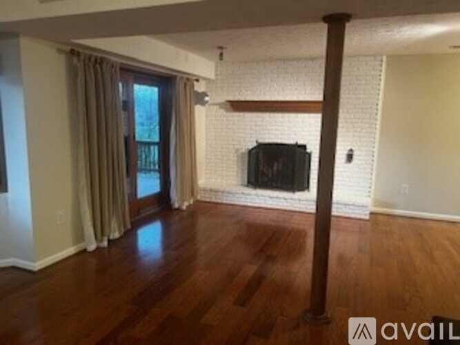 A living room with a television and a fireplace.