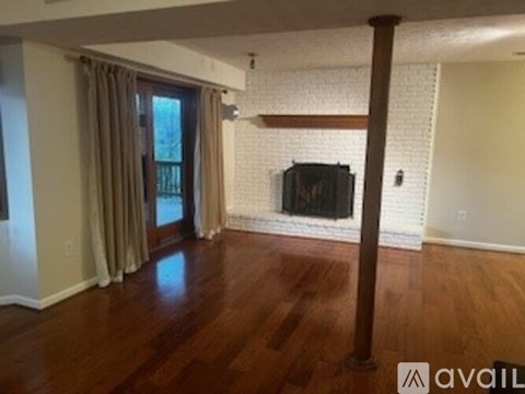 A living room with a television and a fireplace.