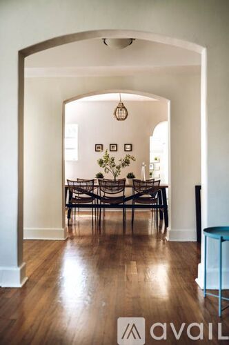 A dining room with a table and chairs.