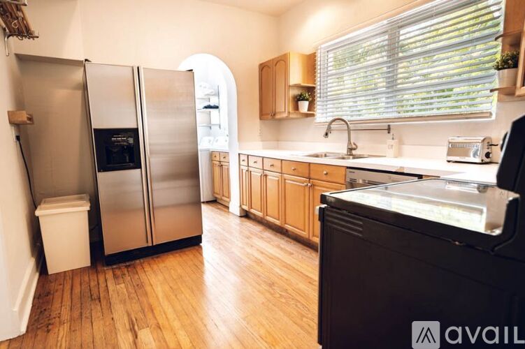 A kitchen with a refrigerator, sink, and oven.