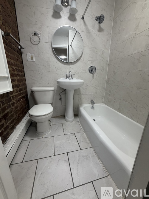 A white toilet and sink in a bathroom.