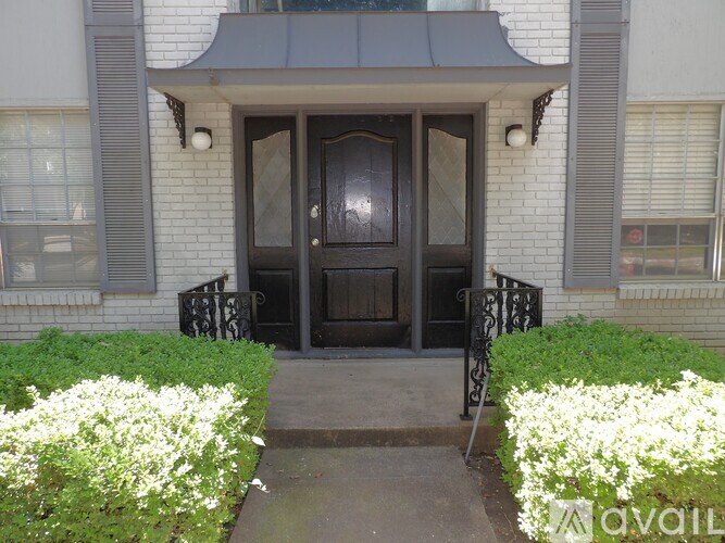A house entrance with a black door and a glass window.