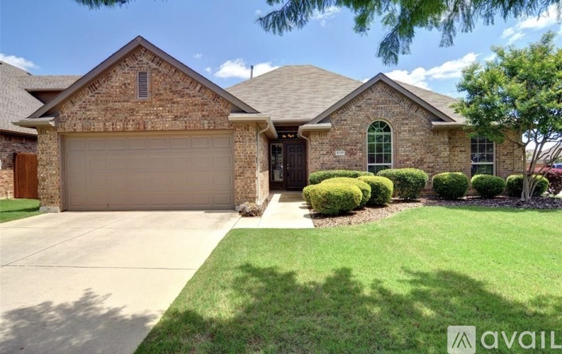 A house with a garage and a driveway in front.