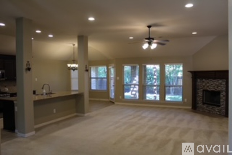 A spacious living room with a fireplace and sliding glass doors.