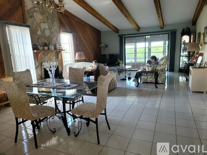 A dining room with a glass table and chairs.