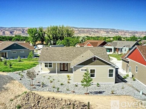 A row of houses with a mountain in the background.