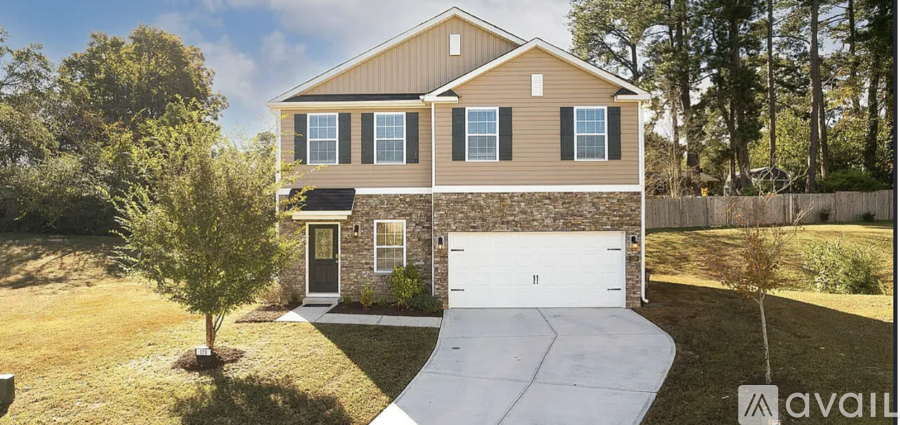 A house with a garage and a driveway is available for sale.