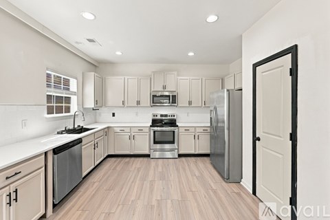 A spacious room with a ceiling fan and carpeted floor.