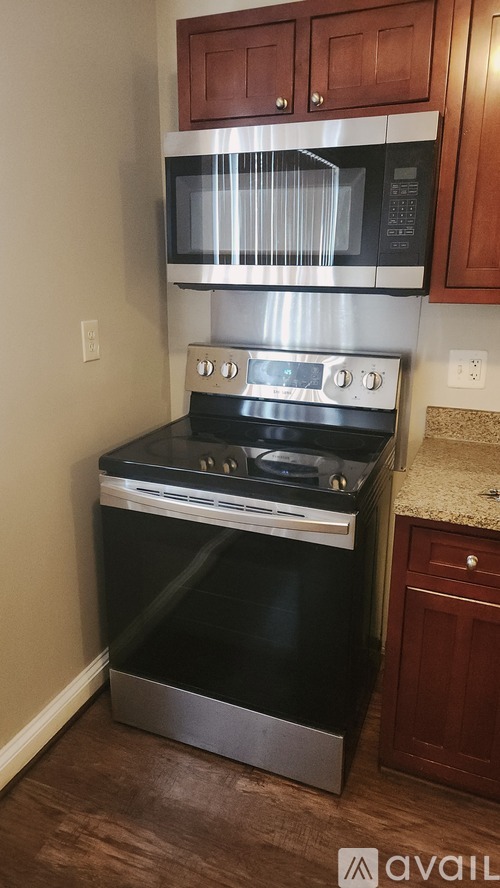 A kitchen with a black oven and microwave.