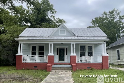 A white house with a red front porch is for rent.