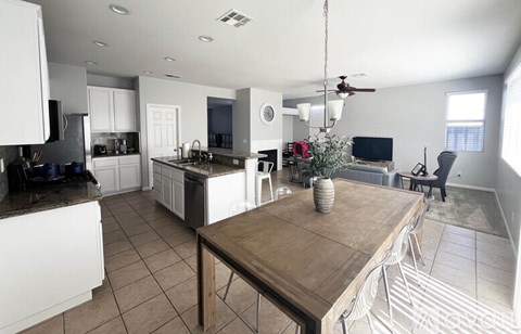 A modern kitchen with a wooden table and chairs.
