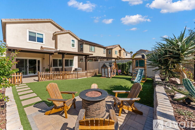 A house with a patio and lawn chairs.