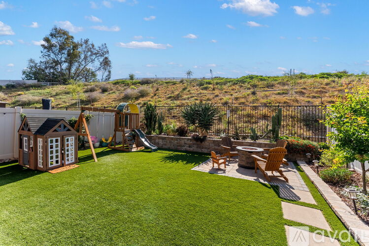 A backyard with a playground and a slide.