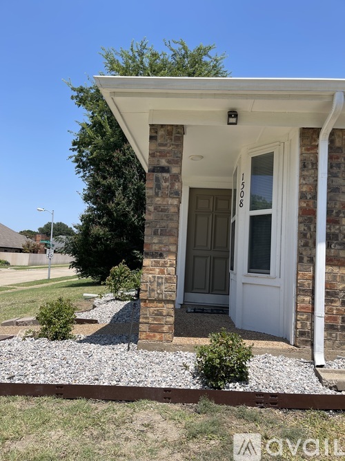 A small house with a white door and a porch.