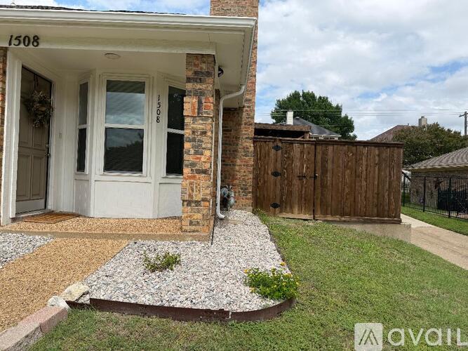 A house numbered 1508 with a white door and a brick pillar.