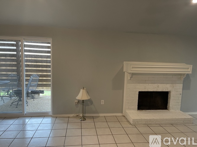 A living room with a fireplace and sliding glass doors.