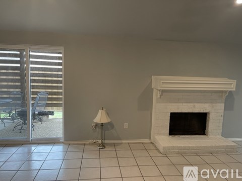 A living room with a fireplace and sliding glass doors.