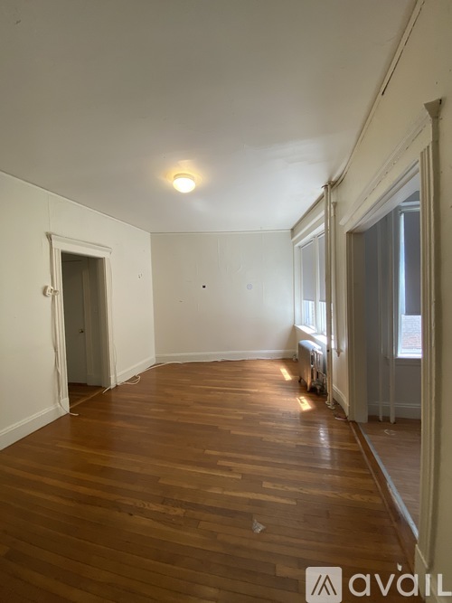 A room with wooden floors and white walls.