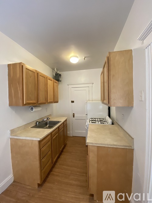 A kitchen with wooden cabinets and a countertop.
