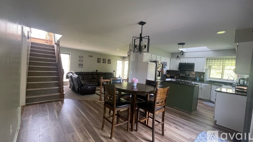 A kitchen with a dining table and chairs is available for rent.