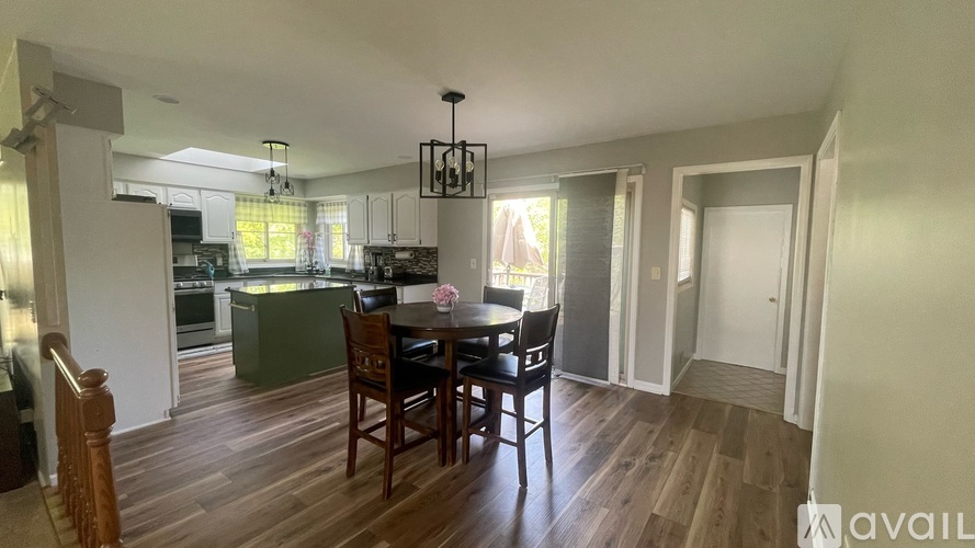 A dining room with a table set for four.