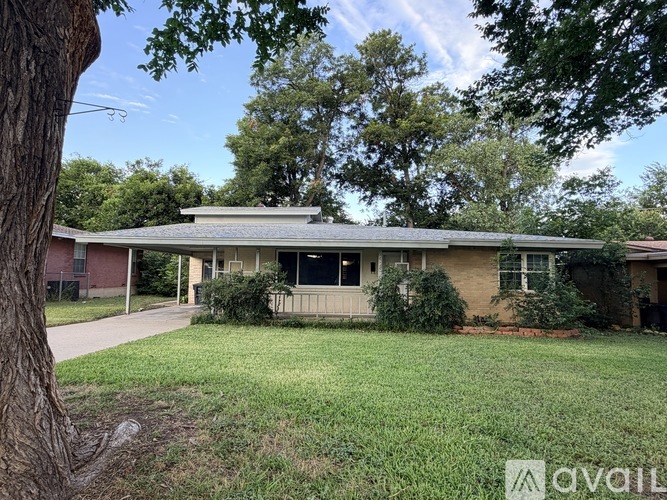 A house with a tree in front of it.