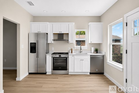 A kitchen with white cabinets and stainless steel appliances.