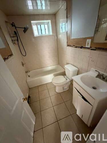 A bathroom with a toilet, sink, and bathtub.