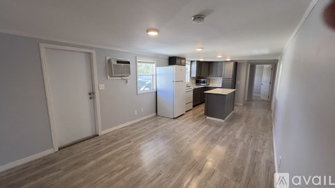 A kitchen with a refrigerator, microwave, and oven is available for rent.