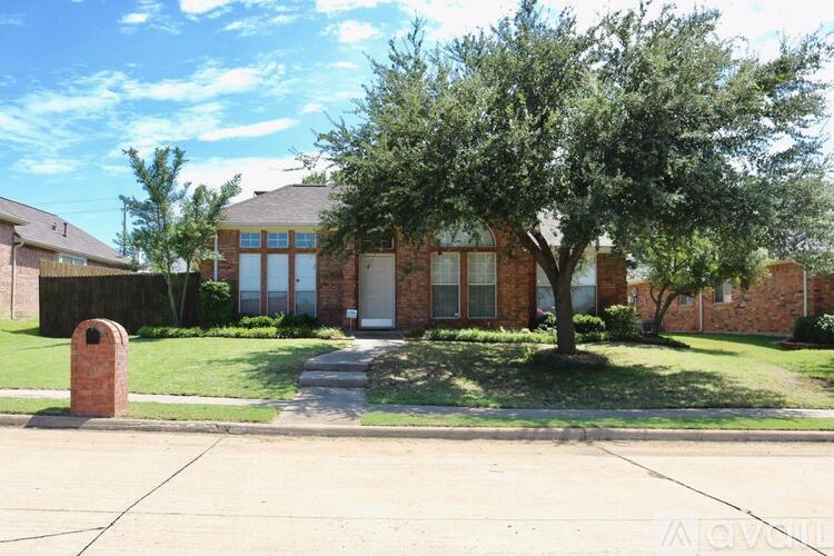 A house with a tree in front of it.