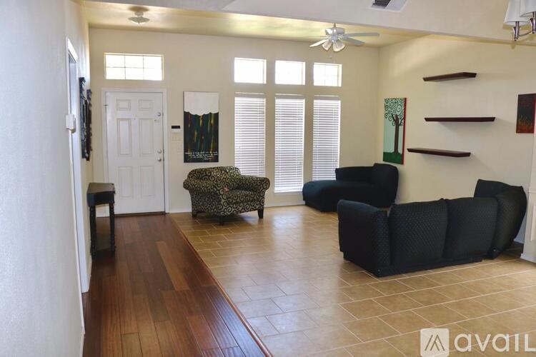 A living room with a couch, chair, and a table.