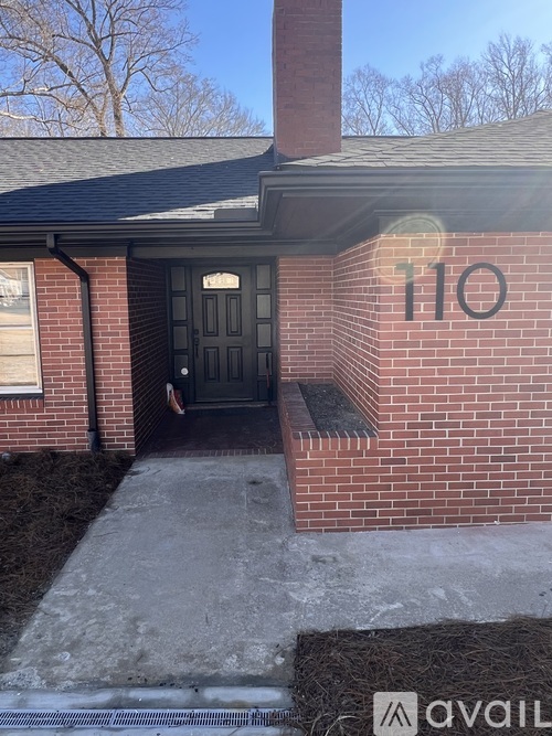A brick house with the number 110 on it.