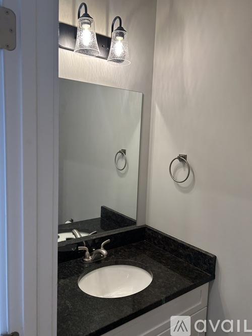 A bathroom with a sink and mirror.