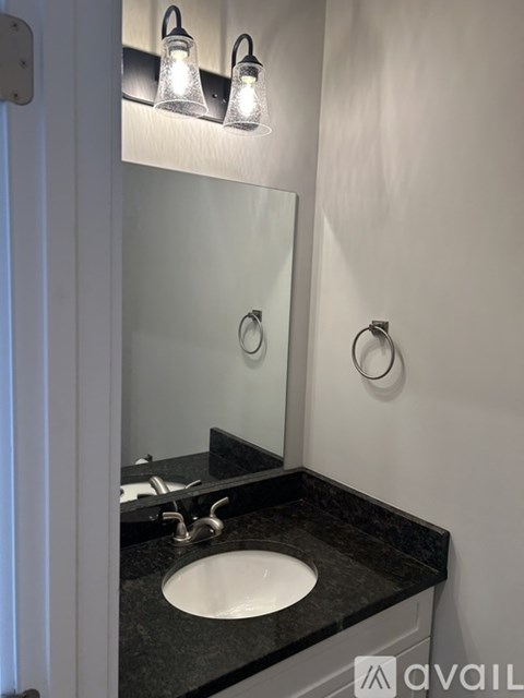 A bathroom with a sink and mirror.